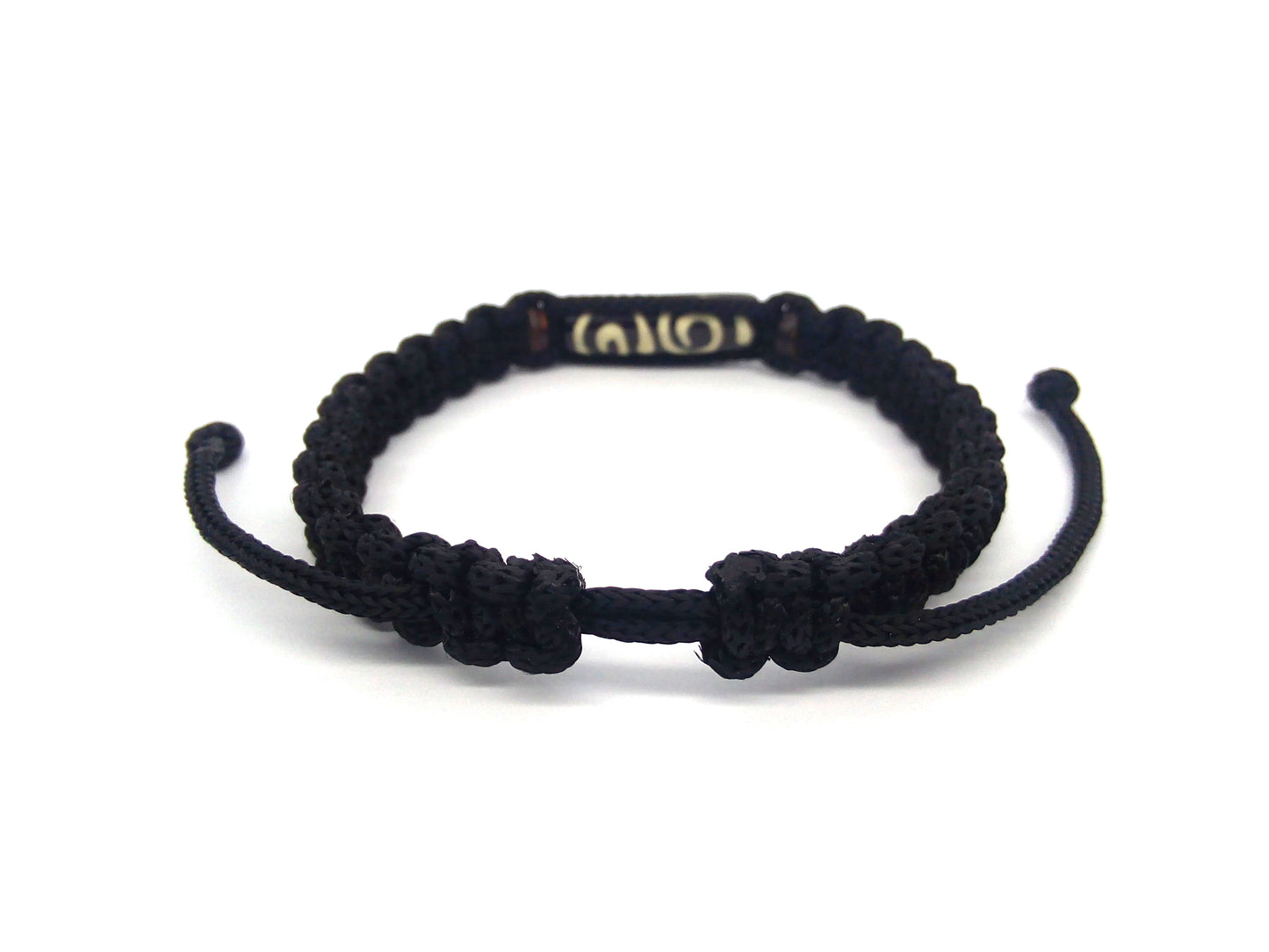 Black braided bracelet on a white background