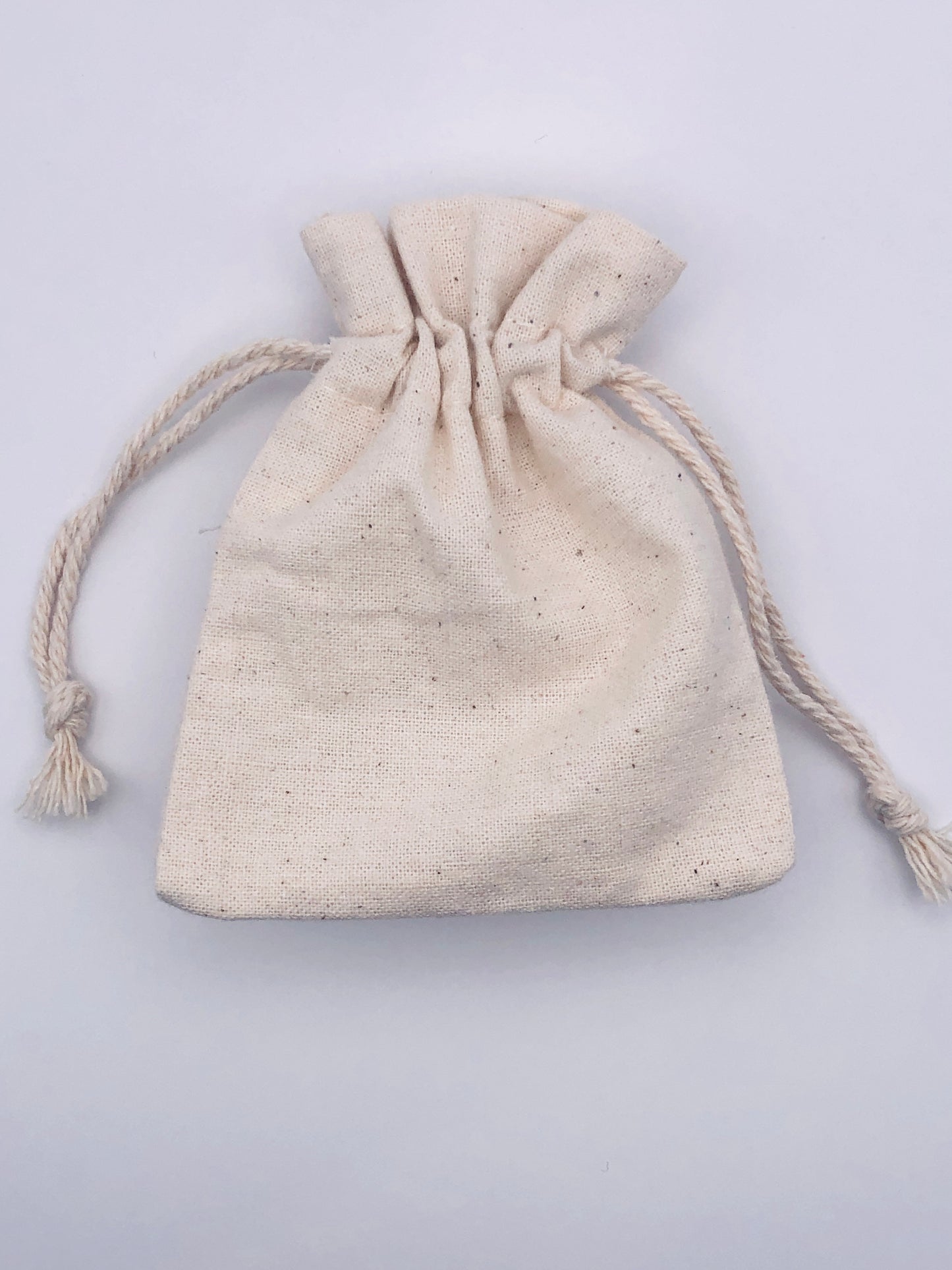 Beige drawstring pouch on a light gray background