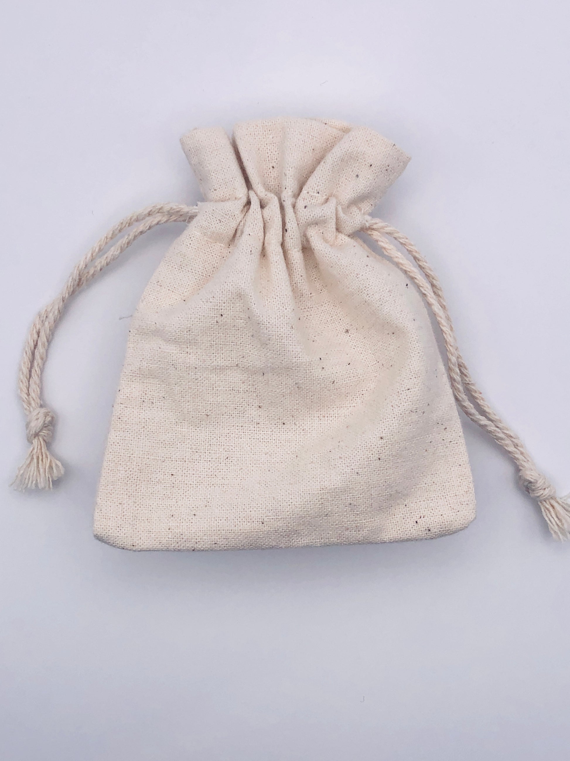 Beige drawstring pouch on a light gray background